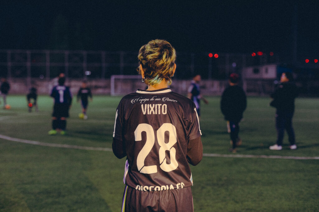 Player from behind showing jersey on the pitch