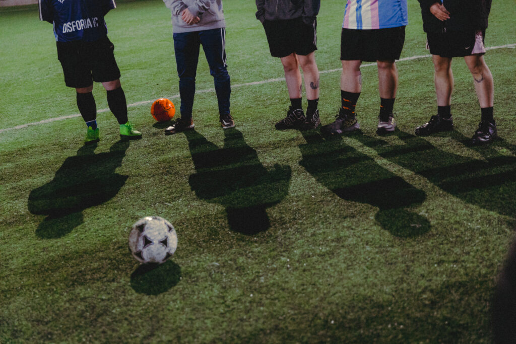 Team feet and shadows next to the ball